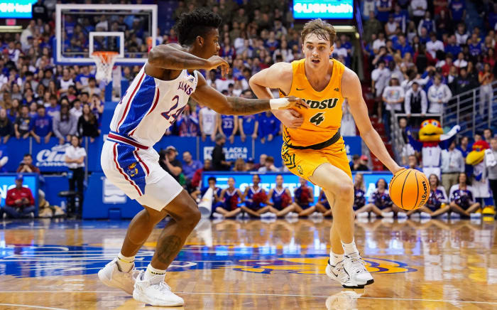 Nov 10, 2022; Lawrence, Kansas, USA; North Dakota State Bison forward Grant Nelson (4) drives against Kansas Jayhawks forward K.J. Adams Jr. (24) during the first half at Allen Fieldhouse. Mandatory Credit: Jay Biggerstaff-USA TODAY Sports